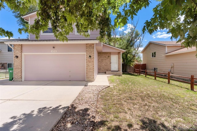 4929 Witches Hollow Ln, Colorado Springs, CO 80911 - view of front of property featuring brick siding, driveway, and a garage