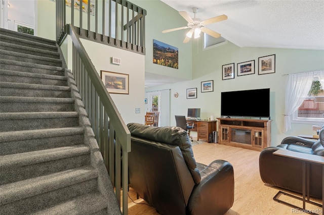 4929 Witches Hollow Ln, Colorado Springs, CO 80911 - living room featuring stairs, wood finished floors, healthy amount of natural light, a ceiling fan, and vaulted ceiling