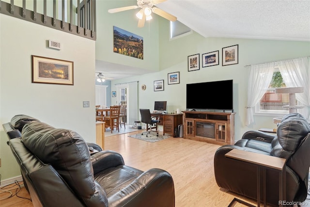4929 Witches Hollow Ln, Colorado Springs, CO 80911 - living room featuring a ceiling fan, light wood-style floors, and high vaulted ceiling