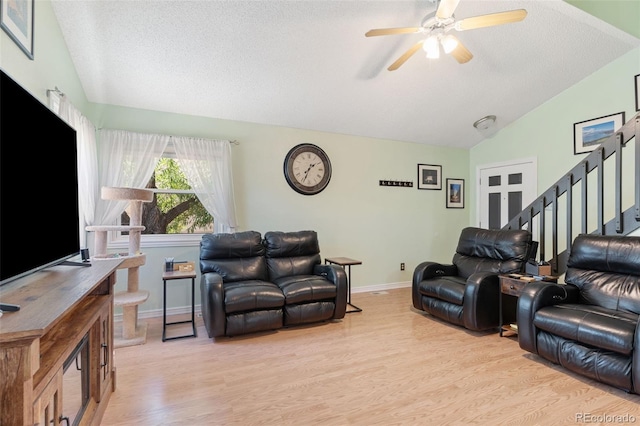 4929 Witches Hollow Ln, Colorado Springs, CO 80911 - living area with lofted ceiling, light wood finished floors, stairs, a textured ceiling, and a ceiling fan