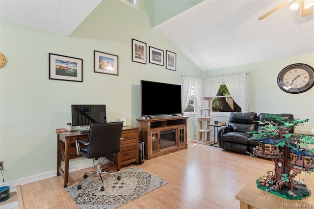 4929 Witches Hollow Ln, Colorado Springs, CO 80911 - home office with vaulted ceiling, wood finished floors, a ceiling fan, and a textured ceiling