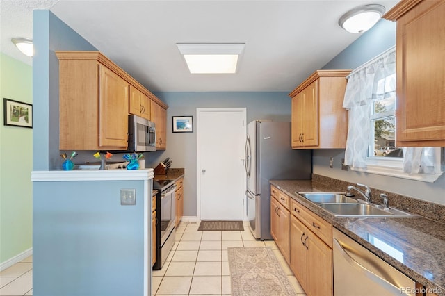 4929 Witches Hollow Ln, Colorado Springs, CO 80911 - kitchen with stainless steel appliances, dark countertops, and light tile patterned floors