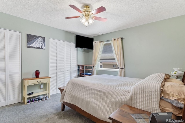 4929 Witches Hollow Ln, Colorado Springs, CO 80911 - carpeted bedroom featuring two closets, a textured ceiling, and ceiling fan