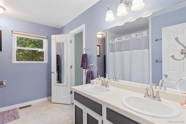 4929 Witches Hollow Ln, Colorado Springs, CO 80911 - full bath with double vanity, tile patterned flooring, and a chandelier