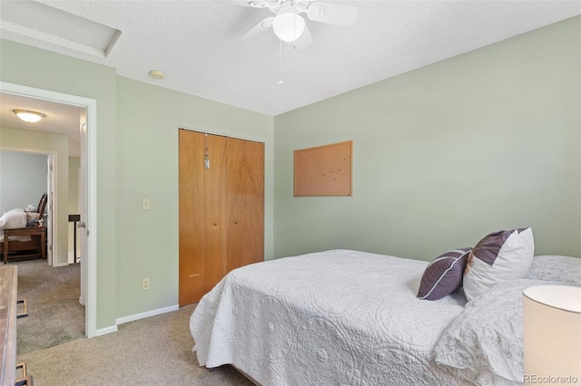 4929 Witches Hollow Ln, Colorado Springs, CO 80911 - bedroom with carpet, a closet, a textured ceiling, ceiling fan, and attic access