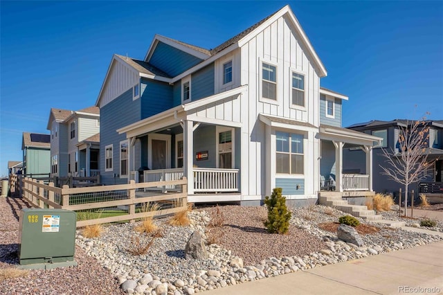 view of front facade with a residential view, a porch, and board and batten siding