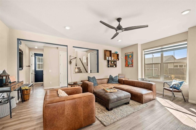 living room with light wood-type flooring, baseboards, a ceiling fan, and recessed lighting