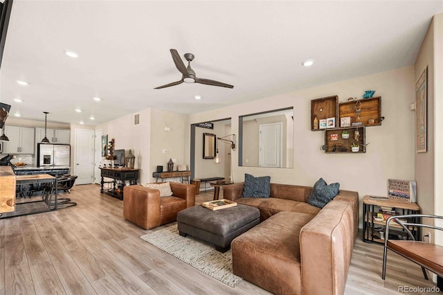 living area with ceiling fan, recessed lighting, and light wood-style floors