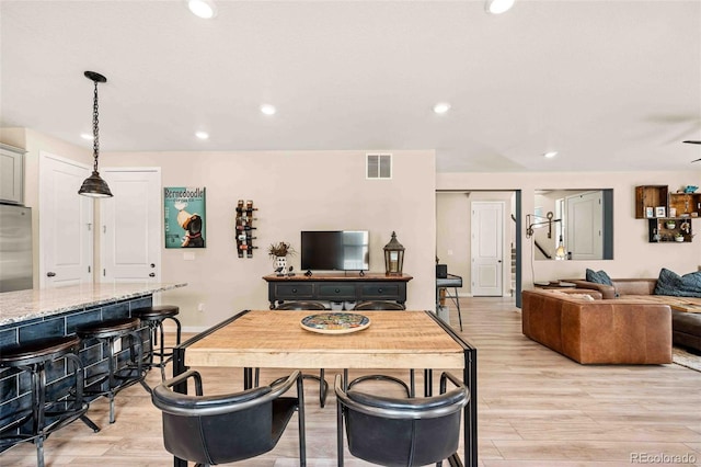 dining room with recessed lighting, visible vents, and light wood finished floors