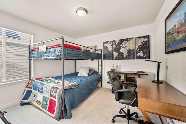 carpeted bedroom with baseboards