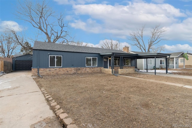 ranch-style home featuring a garage and an outdoor structure