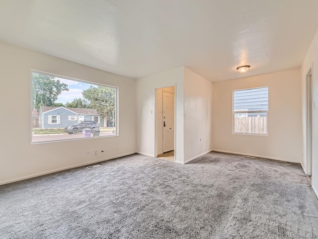 1850 W 50th Ave, Denver, CO 80221 - unfurnished bedroom featuring multiple windows and carpet floors