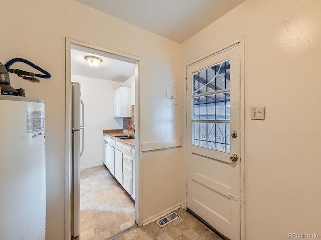 1850 W 50th Ave, Denver, CO 80221 - doorway to outside with water heater and a sink