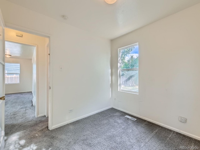 1850 W 50th Ave, Denver, CO 80221 - spare room with carpet flooring, healthy amount of natural light, and a smoke detector