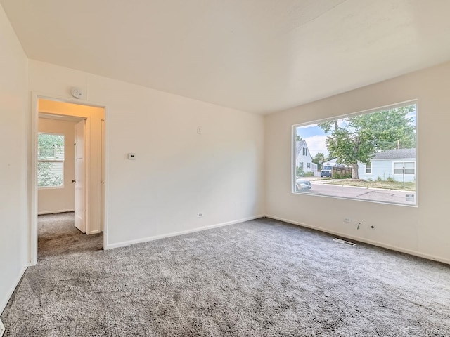 1850 W 50th Ave, Denver, CO 80221 - carpeted empty room featuring healthy amount of natural light and a smoke detector