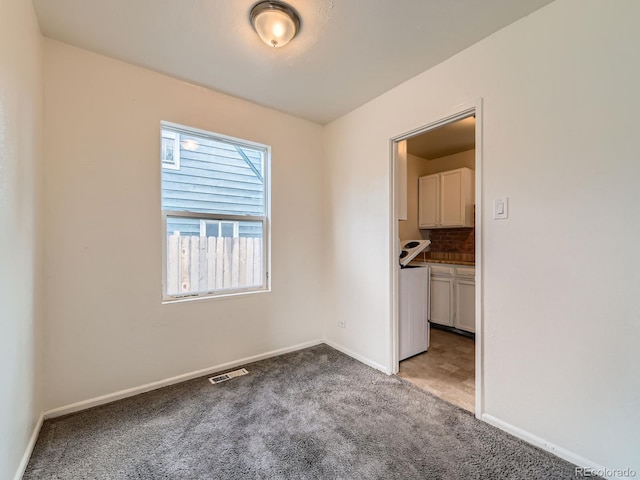 1850 W 50th Ave, Denver, CO 80221 - empty room featuring light carpet and baseboards