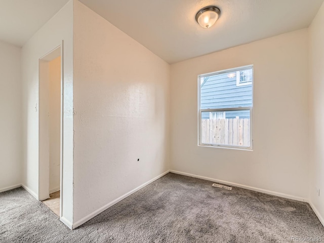 1850 W 50th Ave, Denver, CO 80221 - carpeted empty room with baseboards