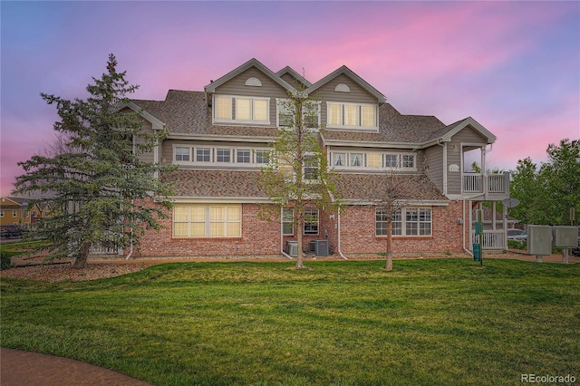 16320 E Fremont Ave Unit 1, Aurora, CO 80016 - view of front facade featuring a front lawn, brick siding, a balcony, and cooling unit