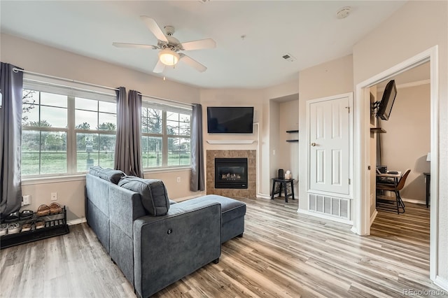 16320 E Fremont Ave Unit 1, Aurora, CO 80016 - living area featuring a ceiling fan, baseboards, light wood-type flooring, and a tile fireplace