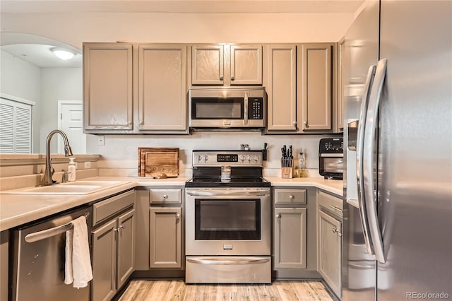 16320 E Fremont Ave Unit 1, Aurora, CO 80016 - kitchen with stainless steel appliances, a sink, gray cabinets, and light countertops