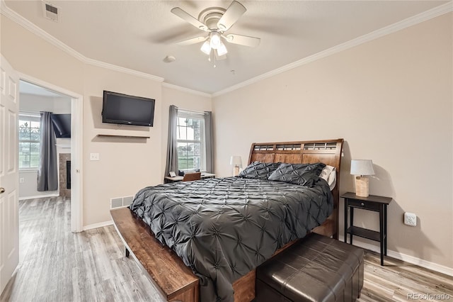 16320 E Fremont Ave Unit 1, Aurora, CO 80016 - bedroom featuring light wood finished floors, baseboards, crown molding, and ceiling fan