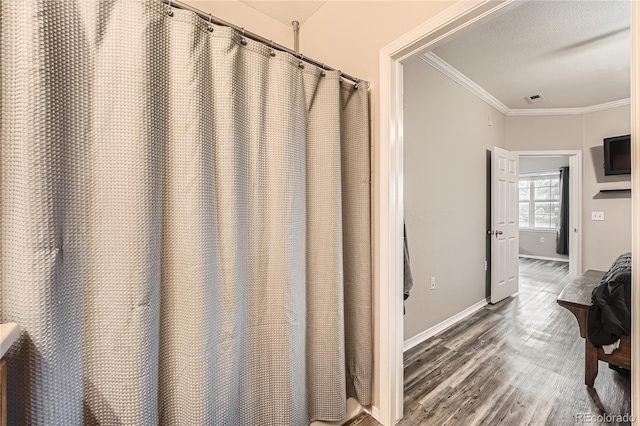 16320 E Fremont Ave Unit 1, Aurora, CO 80016 - bathroom featuring crown molding, wood finished floors, and baseboards
