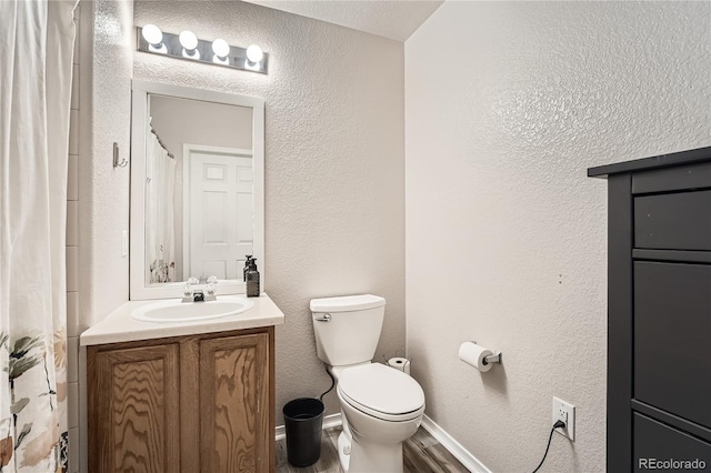 16320 E Fremont Ave Unit 1, Aurora, CO 80016 - bathroom with vanity, toilet, wood finished floors, baseboards, and a shower with curtain
