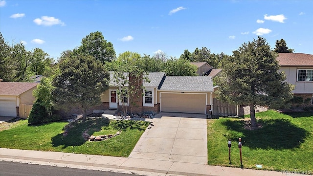 10832 W Powers Pl, Littleton, CO 80127 - view of front of home with a garage, brick siding, and concrete driveway