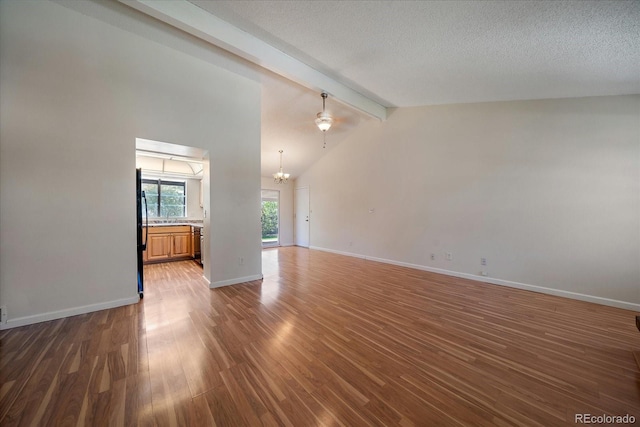 10832 W Powers Pl, Littleton, CO 80127 - unfurnished living room with a chandelier, wood finished floors, baseboards, and a ceiling fan