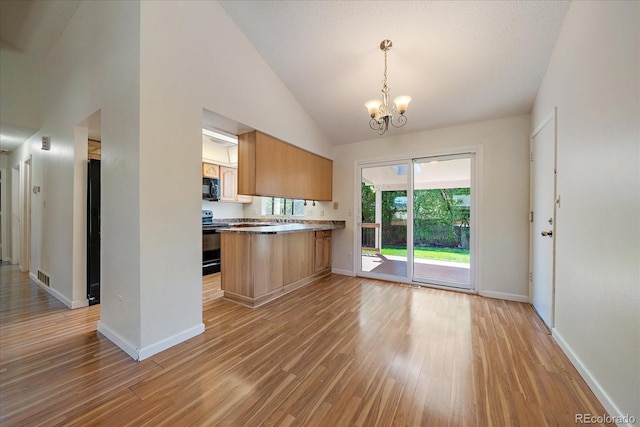 10832 W Powers Pl, Littleton, CO 80127 - kitchen featuring black appliances, a chandelier, light wood-style floors, baseboards, and high vaulted ceiling