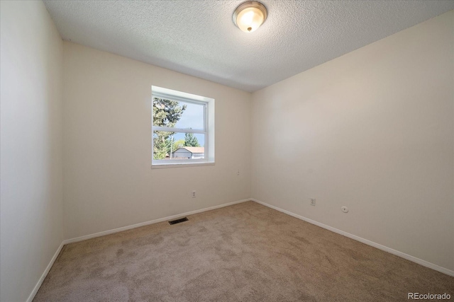10832 W Powers Pl, Littleton, CO 80127 - empty room featuring carpet, baseboards, and a textured ceiling