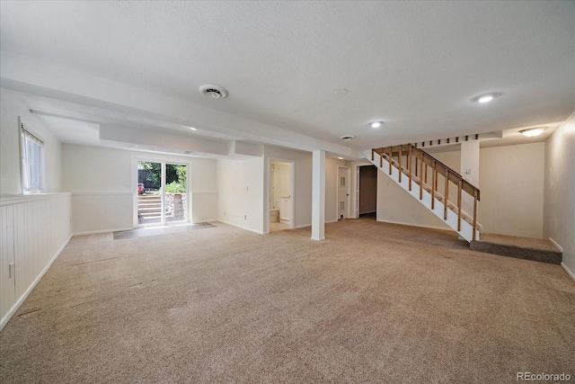 10832 W Powers Pl, Littleton, CO 80127 - below grade area featuring light carpet, stairway, baseboards, and a textured ceiling