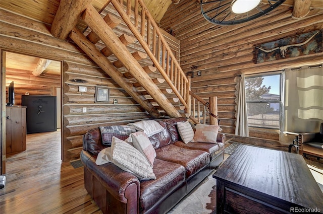 14475 N Yoder Rd, Calhan, CO 80808 - living room with rustic walls, stairway, wood-type flooring, a towering ceiling, and wood ceiling
