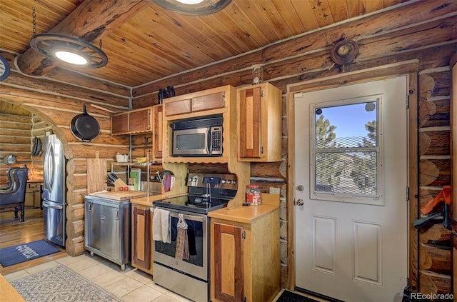 14475 N Yoder Rd, Calhan, CO 80808 - kitchen featuring appliances with stainless steel finishes, rustic walls, wooden ceiling, light countertops, and light tile patterned floors