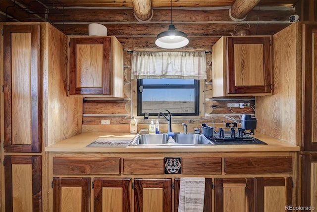 14475 N Yoder Rd, Calhan, CO 80808 - kitchen with a sink, light countertops, brown cabinetry, log walls, and hanging light fixtures