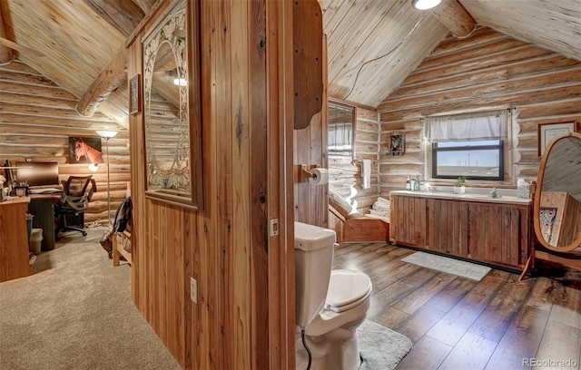14475 N Yoder Rd, Calhan, CO 80808 - bathroom featuring rustic walls, wood ceiling, toilet, beam ceiling, and hardwood / wood-style flooring