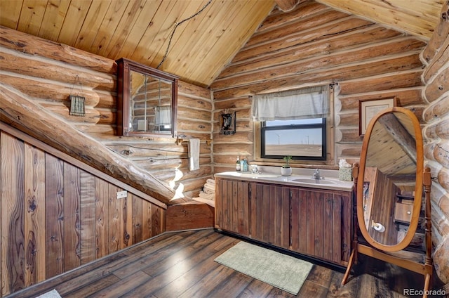 14475 N Yoder Rd, Calhan, CO 80808 - bathroom with vaulted ceiling, log walls, hardwood / wood-style flooring, double vanity, and wooden ceiling