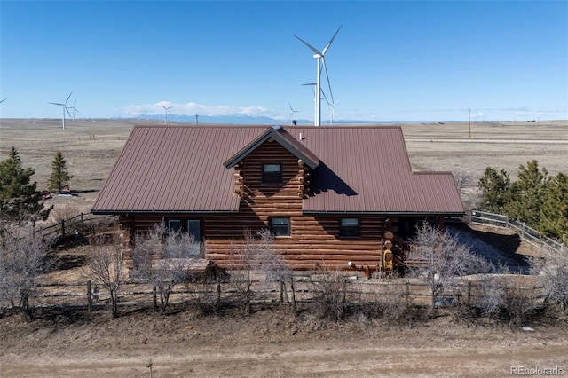 14475 N Yoder Rd, Calhan, CO 80808 - view of side of property featuring log exterior, metal roof, fence, and a view of rural / pastoral area