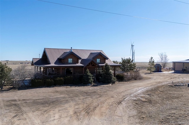 14475 N Yoder Rd, Calhan, CO 80808 - log cabin with dirt driveway, log siding, and metal roof