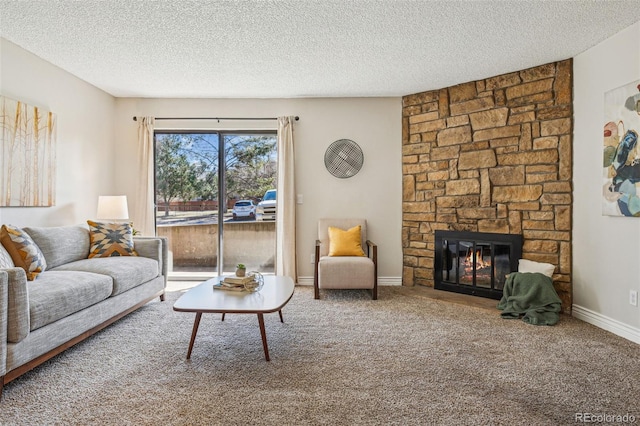 carpeted living area with a fireplace, a textured ceiling, and baseboards