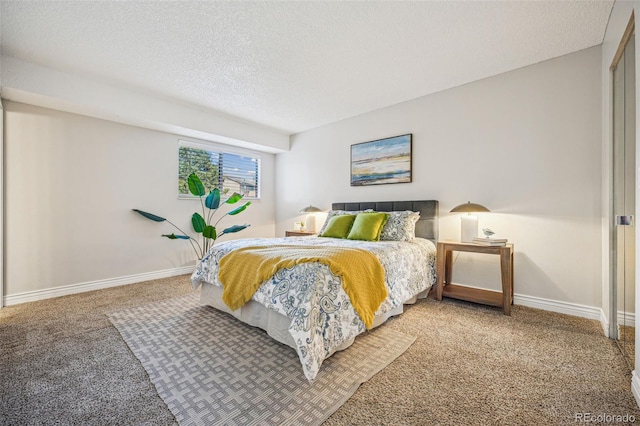 bedroom featuring baseboards, carpet floors, and a textured ceiling