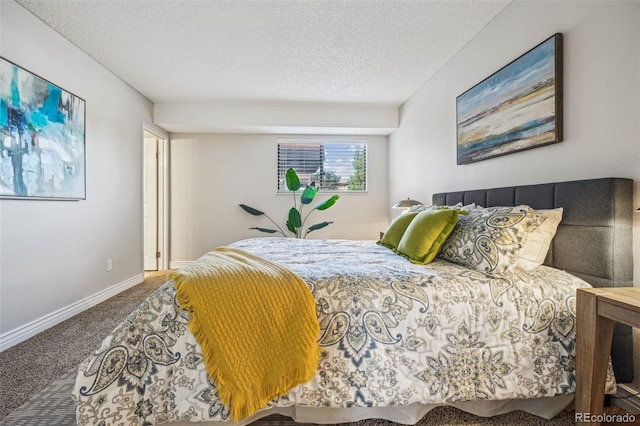 carpeted bedroom featuring baseboards and a textured ceiling
