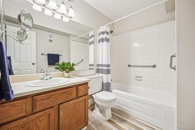 full bathroom with vanity, toilet, wood finished floors, and shower / tub combo