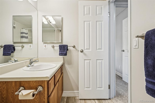 bathroom with vanity and baseboards