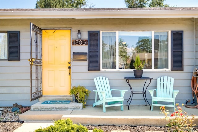 view of exterior entry featuring covered porch