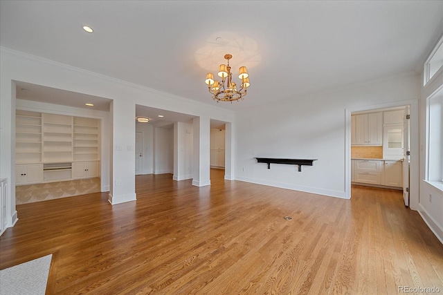 300 Hudson St Unit 203, Denver, CO 80220 - unfurnished living room featuring a chandelier, ornamental molding, light wood finished floors, recessed lighting, and built in features