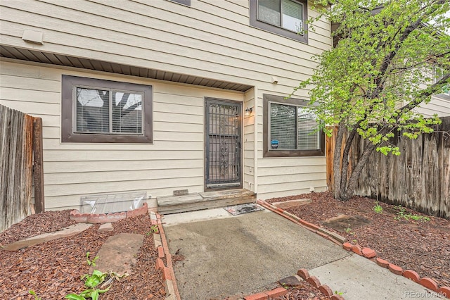 entrance to property featuring fence