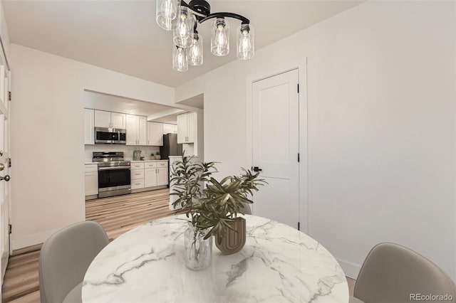 dining space featuring light wood-style floors