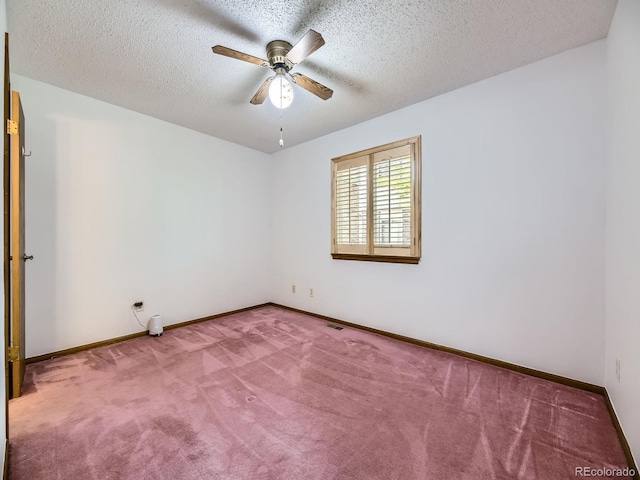 unfurnished room with carpet, ceiling fan, baseboards, and a textured ceiling