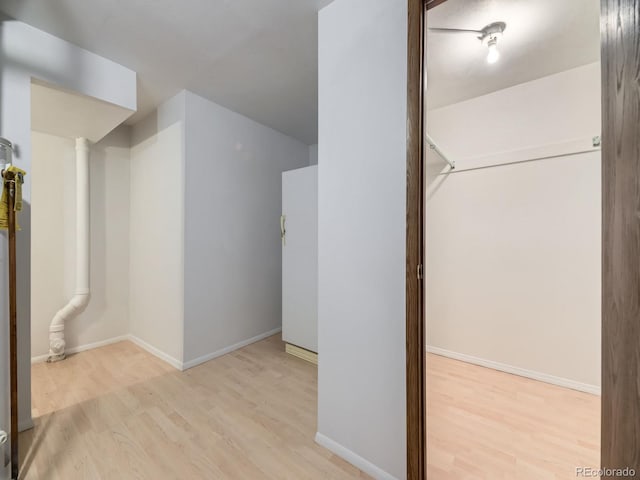 additional living space featuring wood finished floors and baseboards